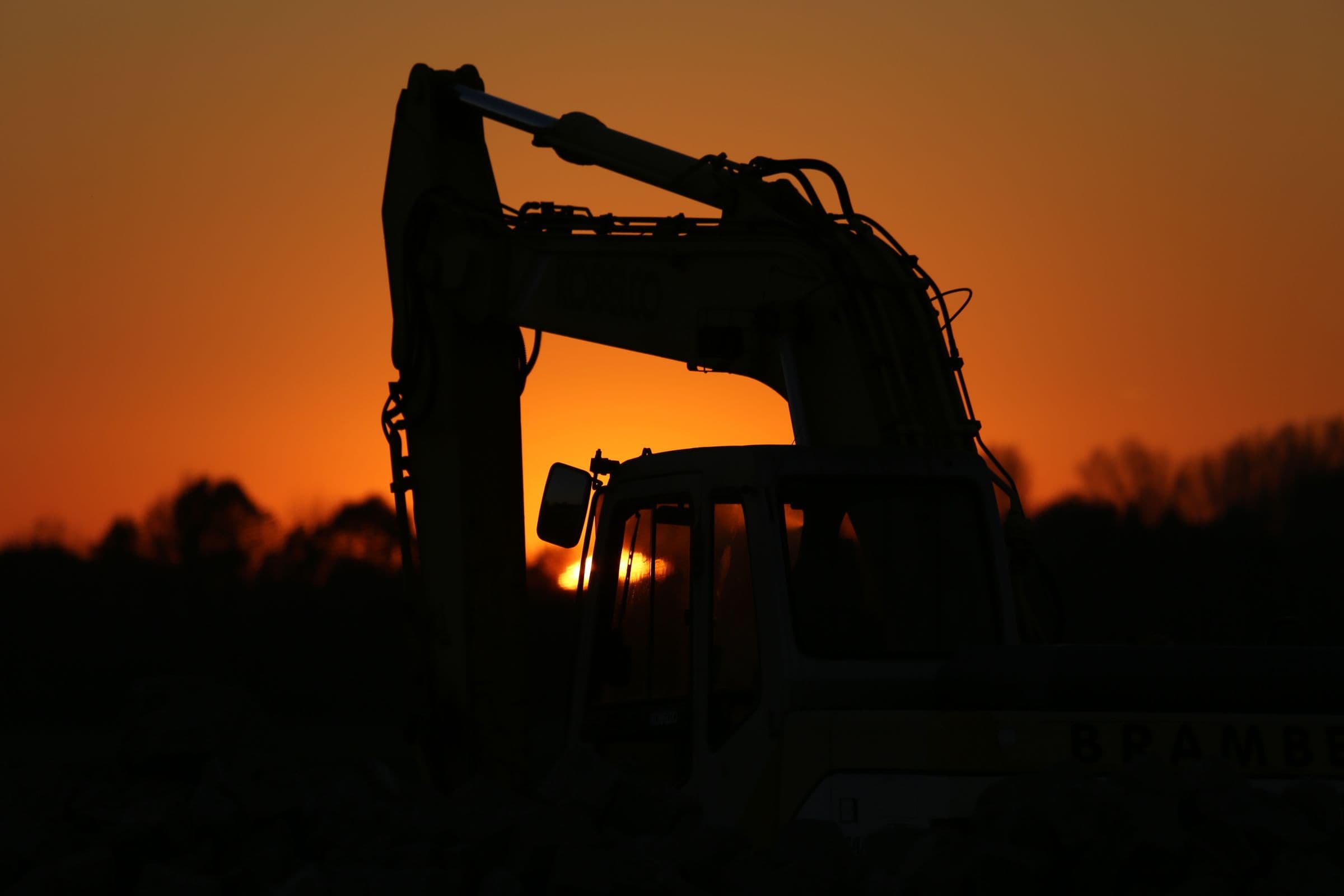 Pelleteuse sur un chantier de terrassement au crépuscule